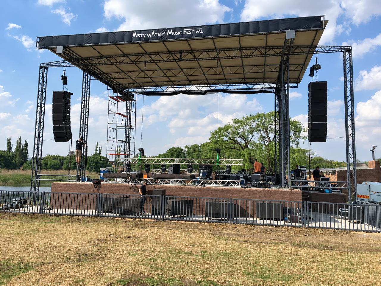 A large festival stage rigged with sound and lighting