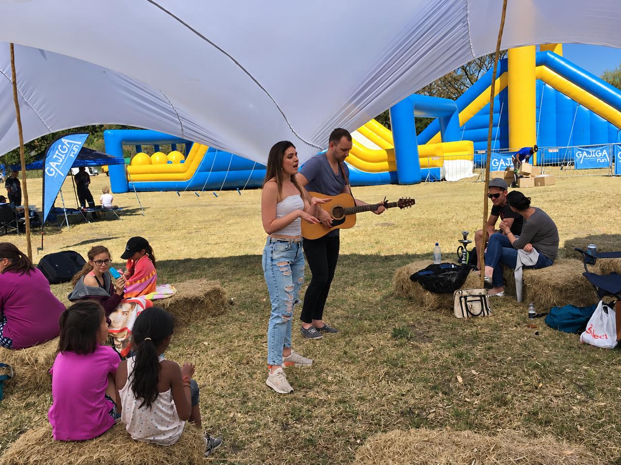 An acoustic duo performing at an outdoor festival