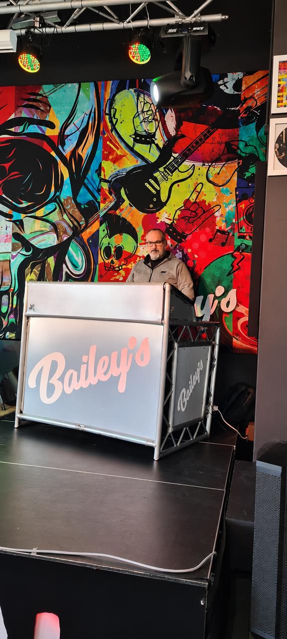 A DJ behind the decks at a lively venue