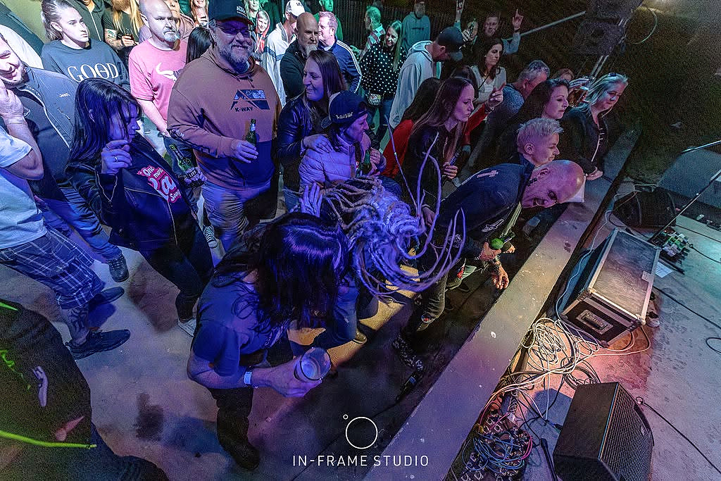 Music fans enjoying a performance beside the stage
